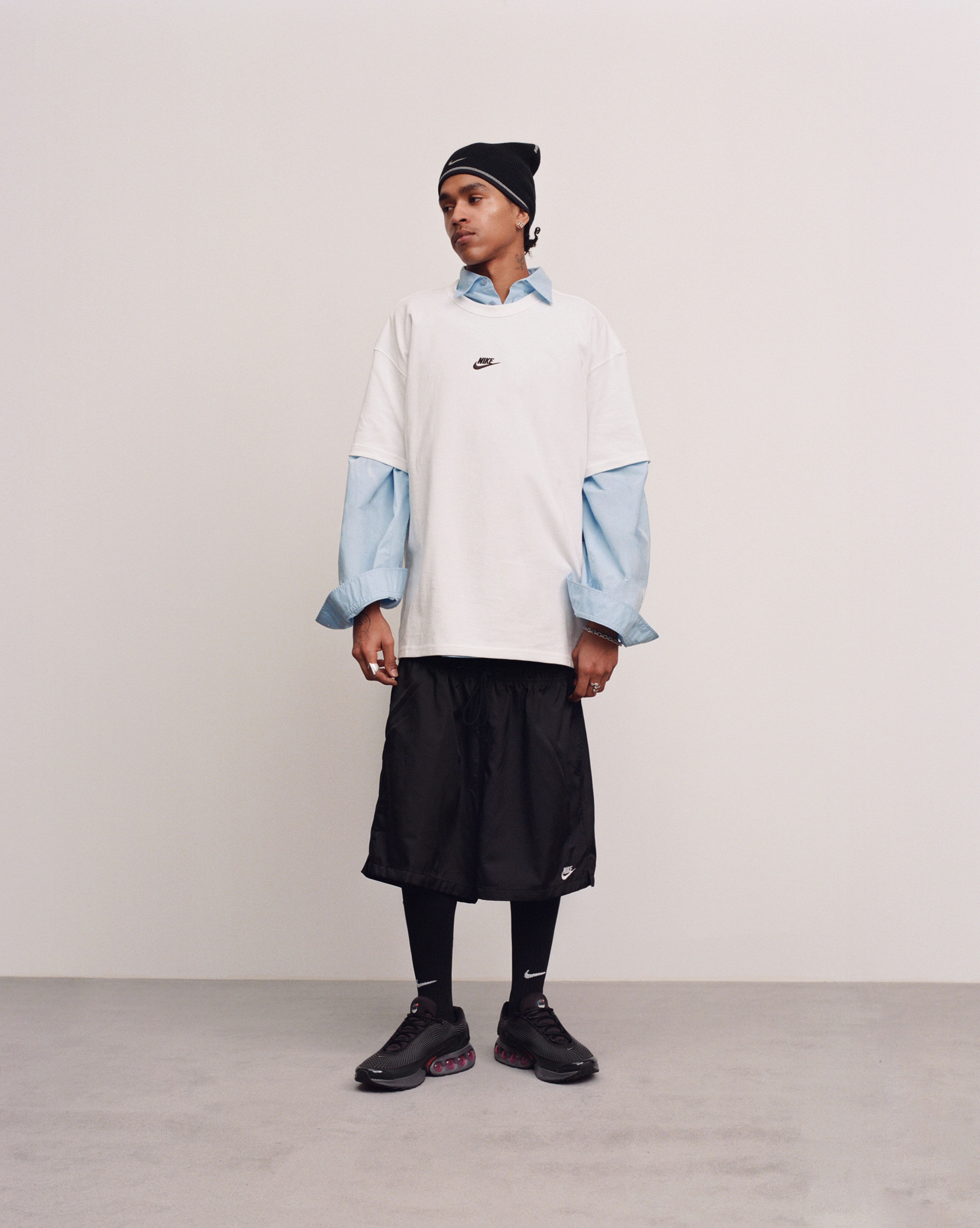 Male model wearing the Nike Air Max Dn in all night colorway while looking to the right