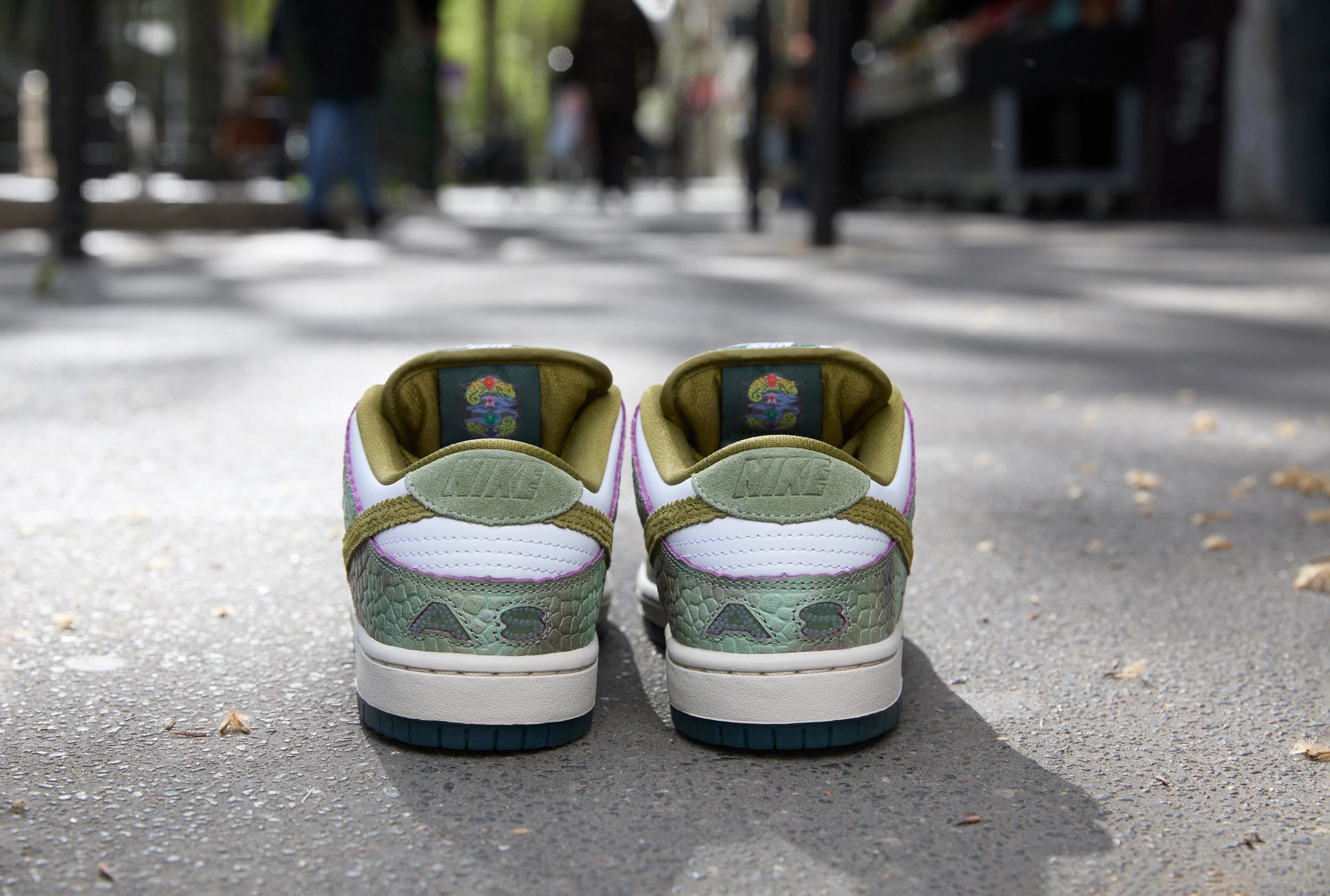 Back view of the Nike SB Dunk Low in oil green and desert moss