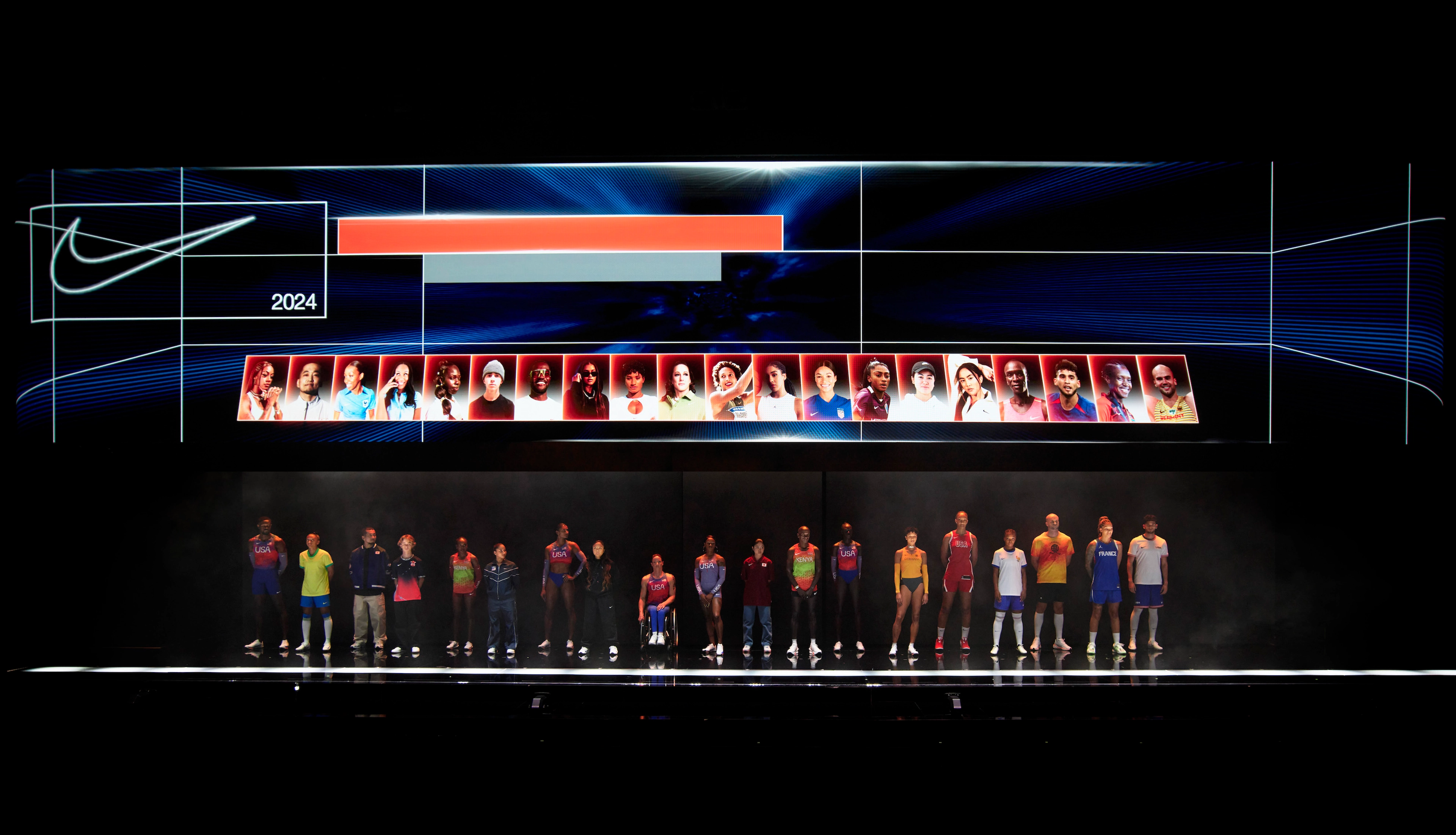 Several athletes pose on a large stage wearing Nike footwear. The athletes' headshot photos are displayed on the overhead screen behind them.