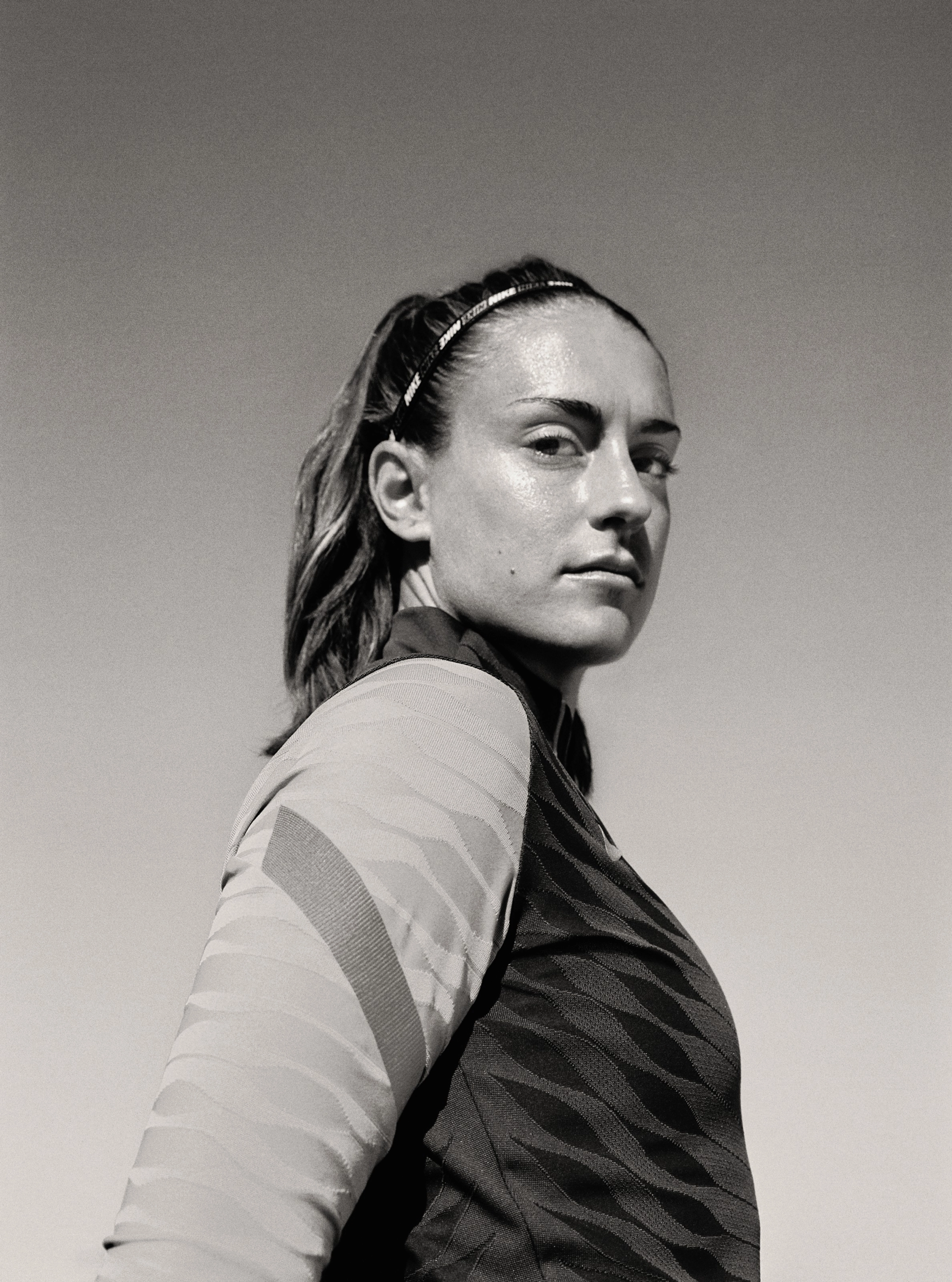 Black and white side angled view of Alexia Putellas with a calm expression.