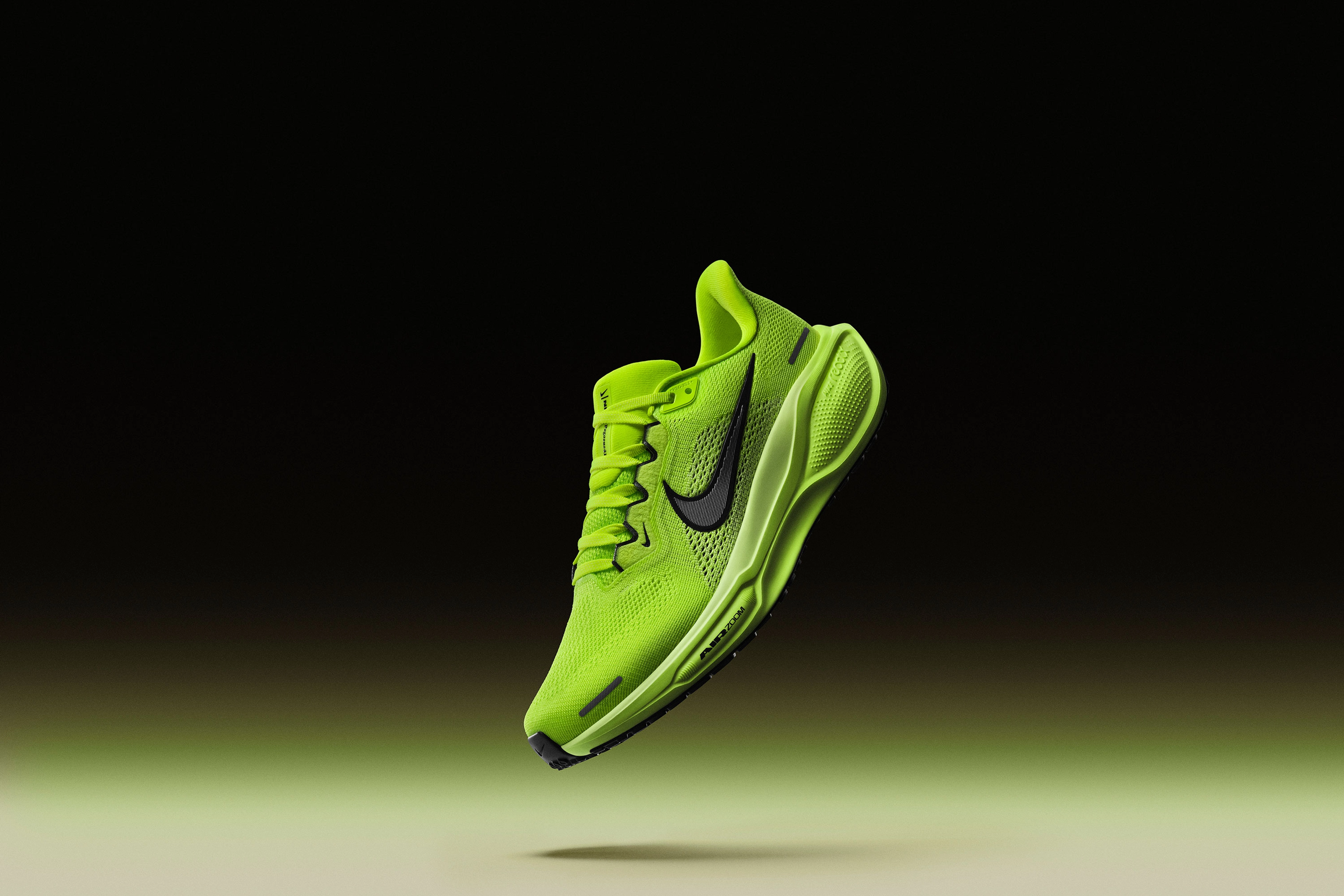 Front angled view of the Nike Pegasus 41 in the Volt green colorway. We see full-length ReactX foam and an Air Zoom Unit in the forefoot. Volt upper, Barely Volt midsole, black sole, with a black Nike Swoosh. The shoe floats above a cream floor, with volt green glow against a dark background.