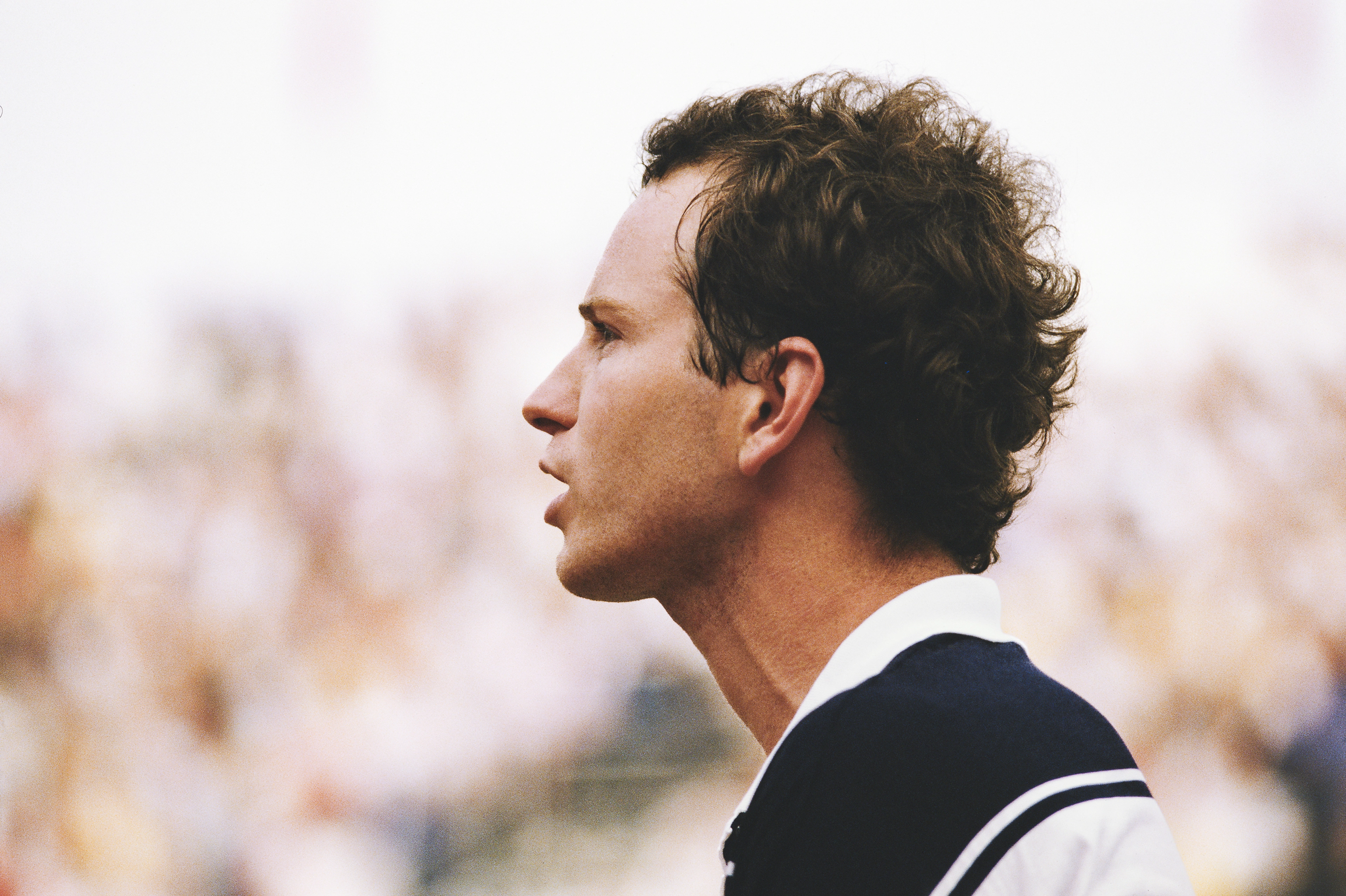 Profile view of young John McEnroe in a speaking pose.