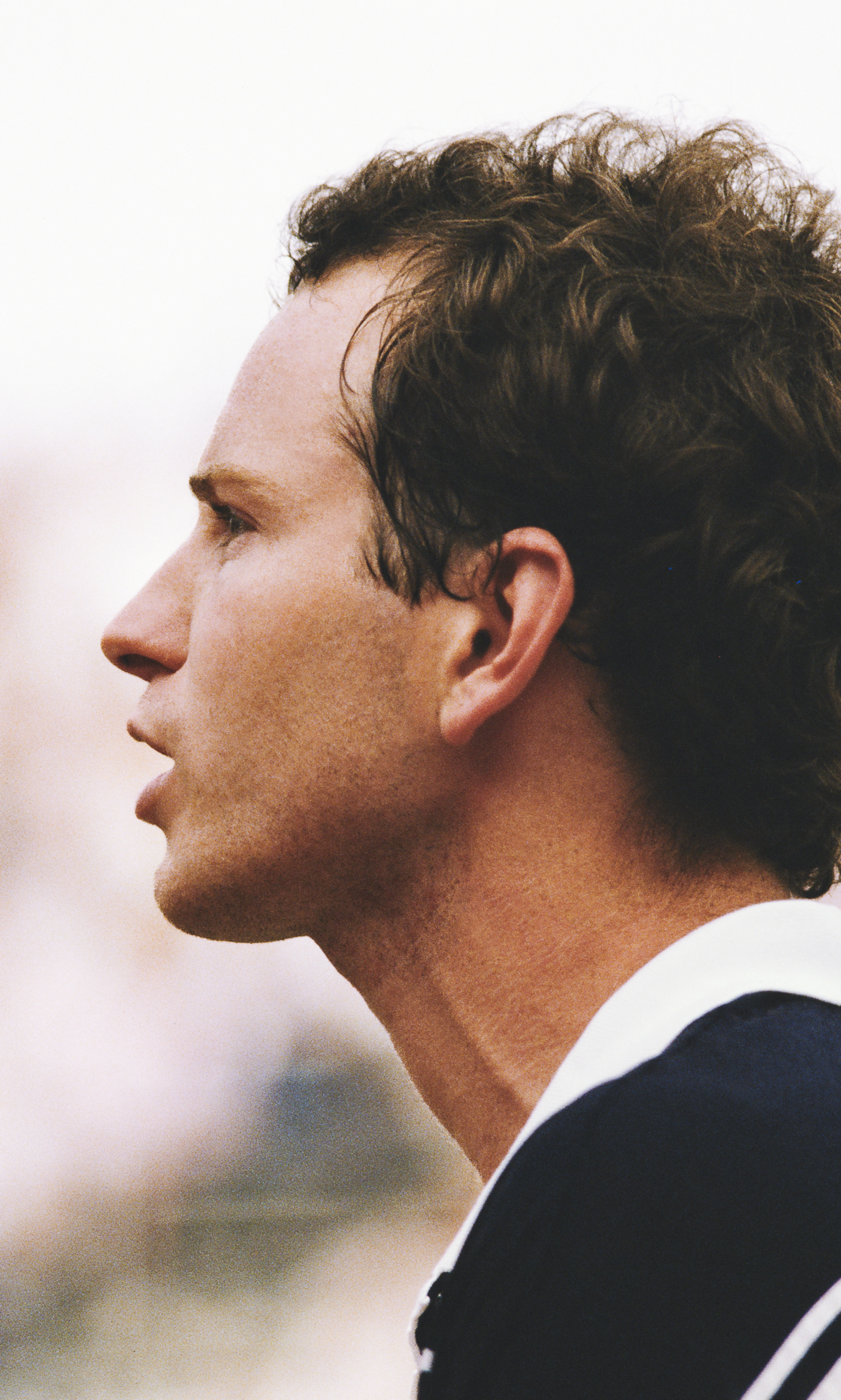 Profile view of young John McEnroe in a speaking pose.