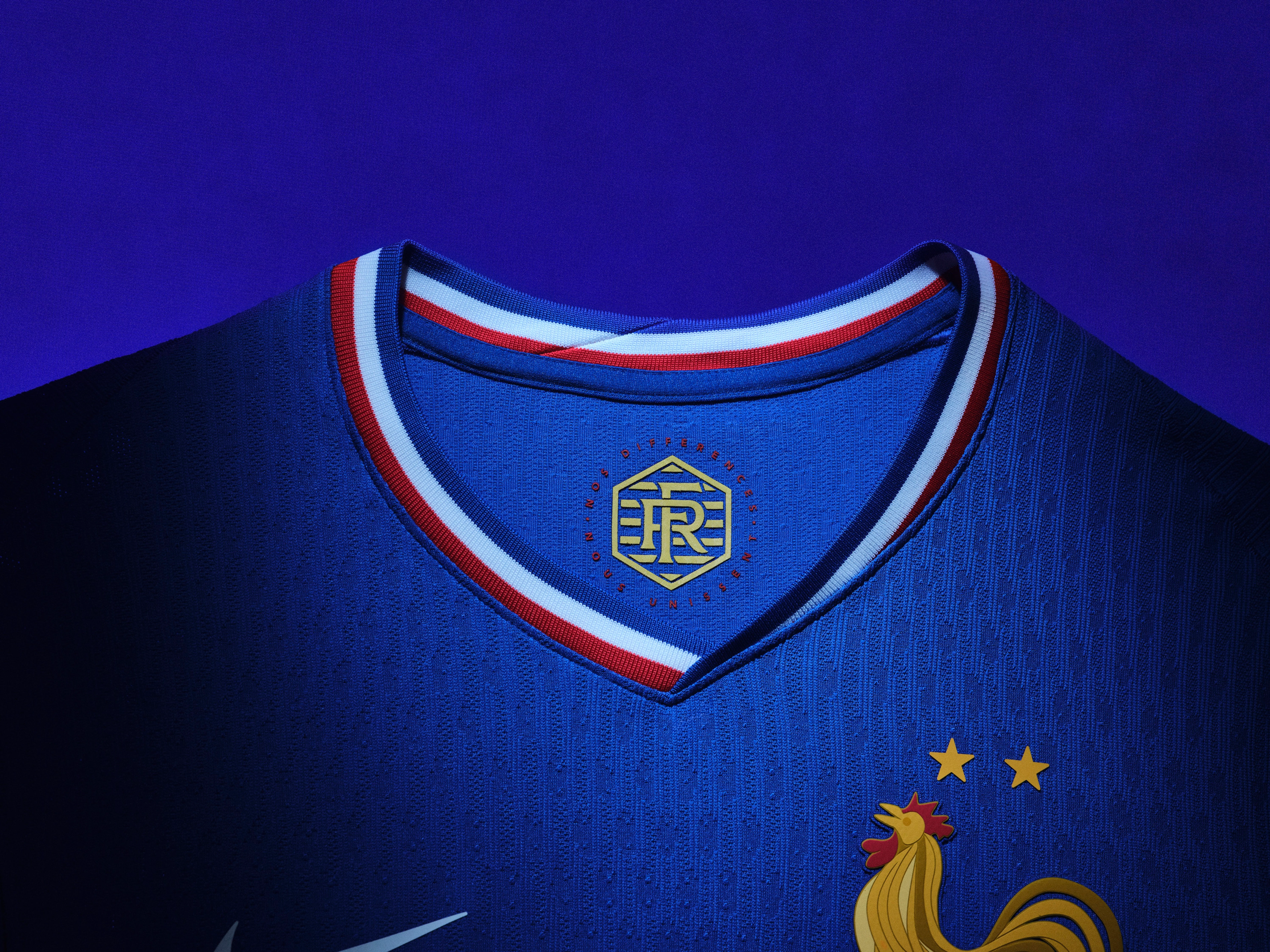 Close up view of the inner collar of a cobalt blue soccer jersey with a red, white, and blue collar and a logo on the back of the collar.