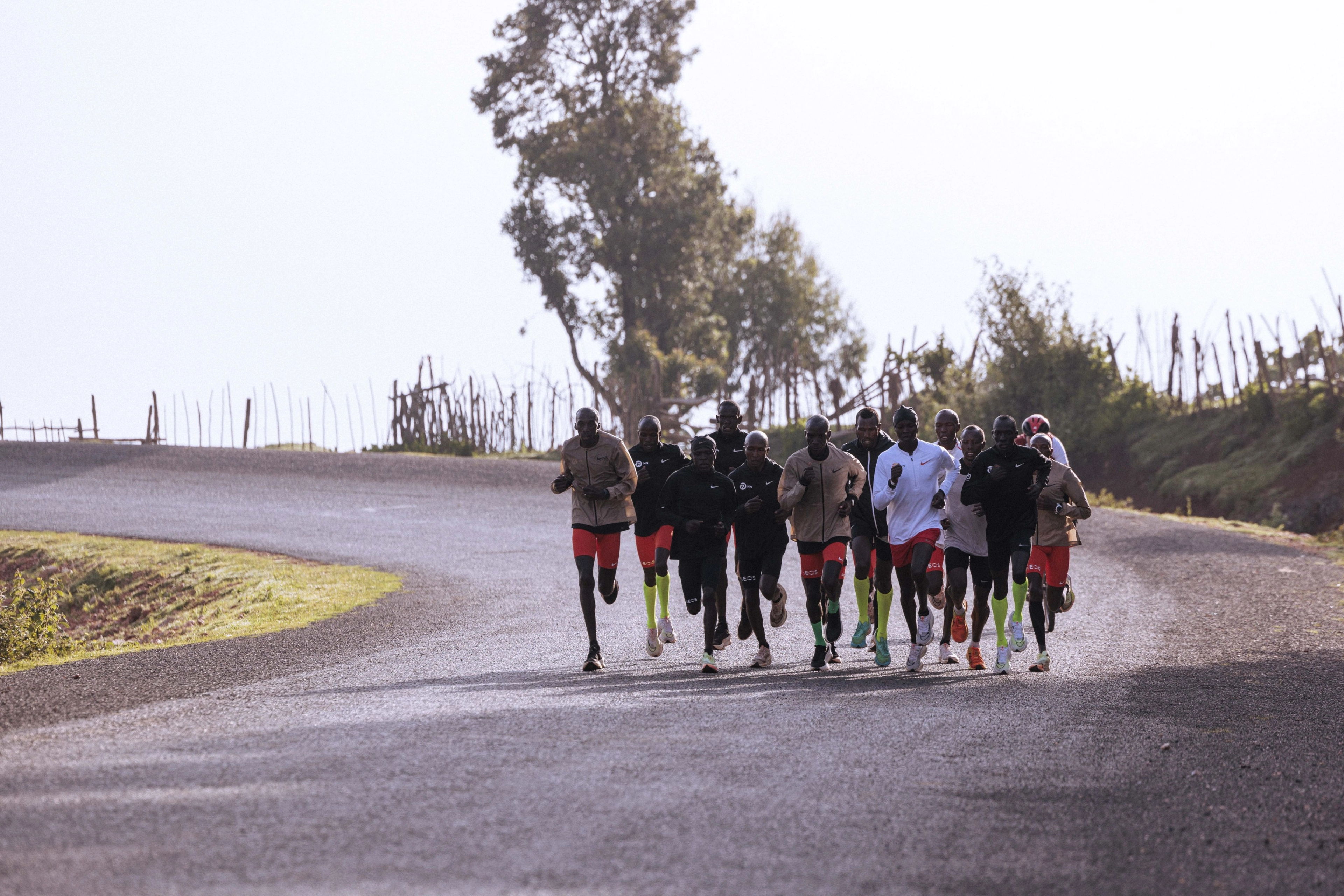 Eliud Kipchoge and teammates training in an outdoor trail in Keptagat, Kenya, while wearing various Nike running shoes to provide feedback.