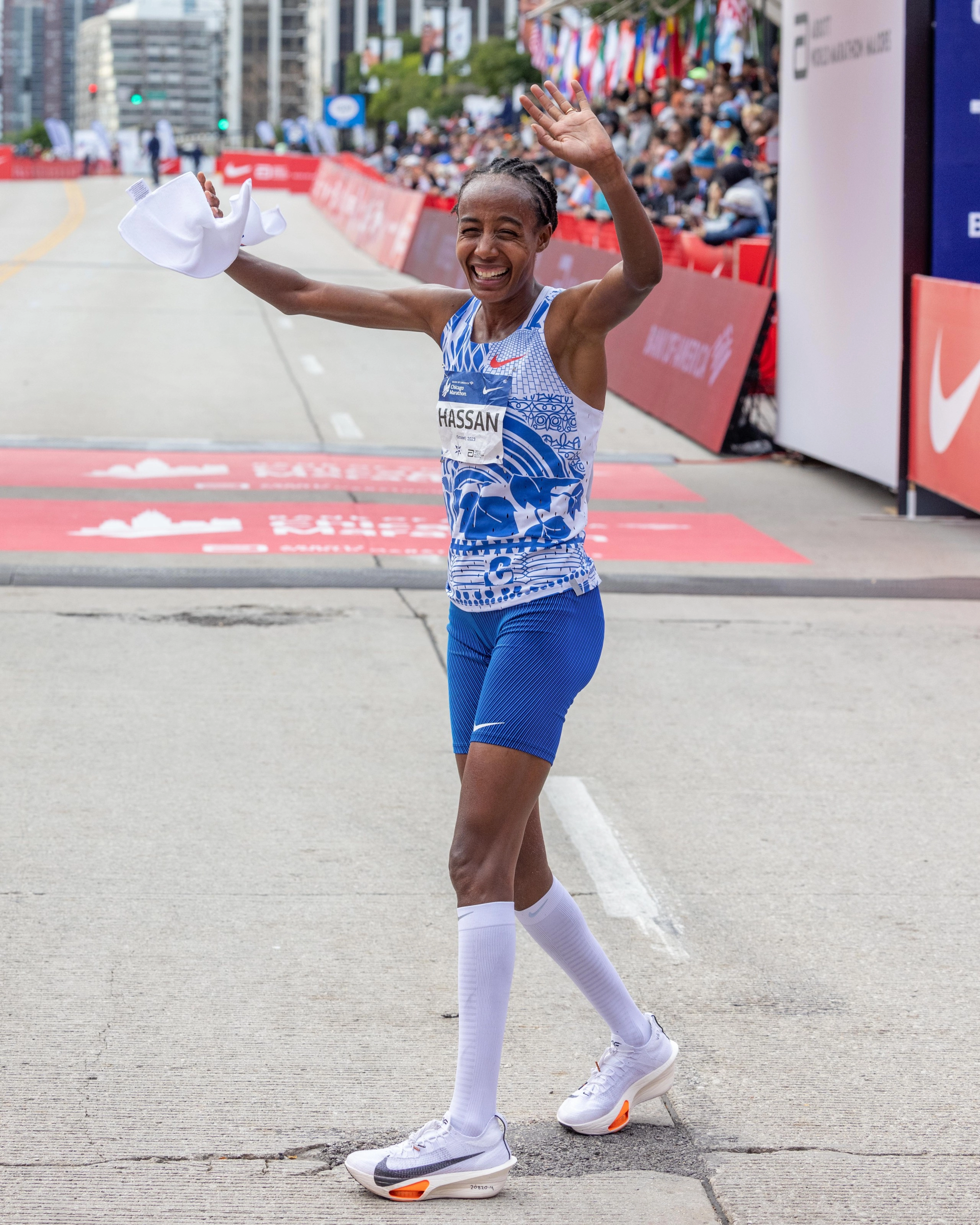 Sifan Hissan wearing the Nike Alphafly 3 and waving at the crowd after running the second fastest women's marathon in history at the 2023 Chicago Marathon.