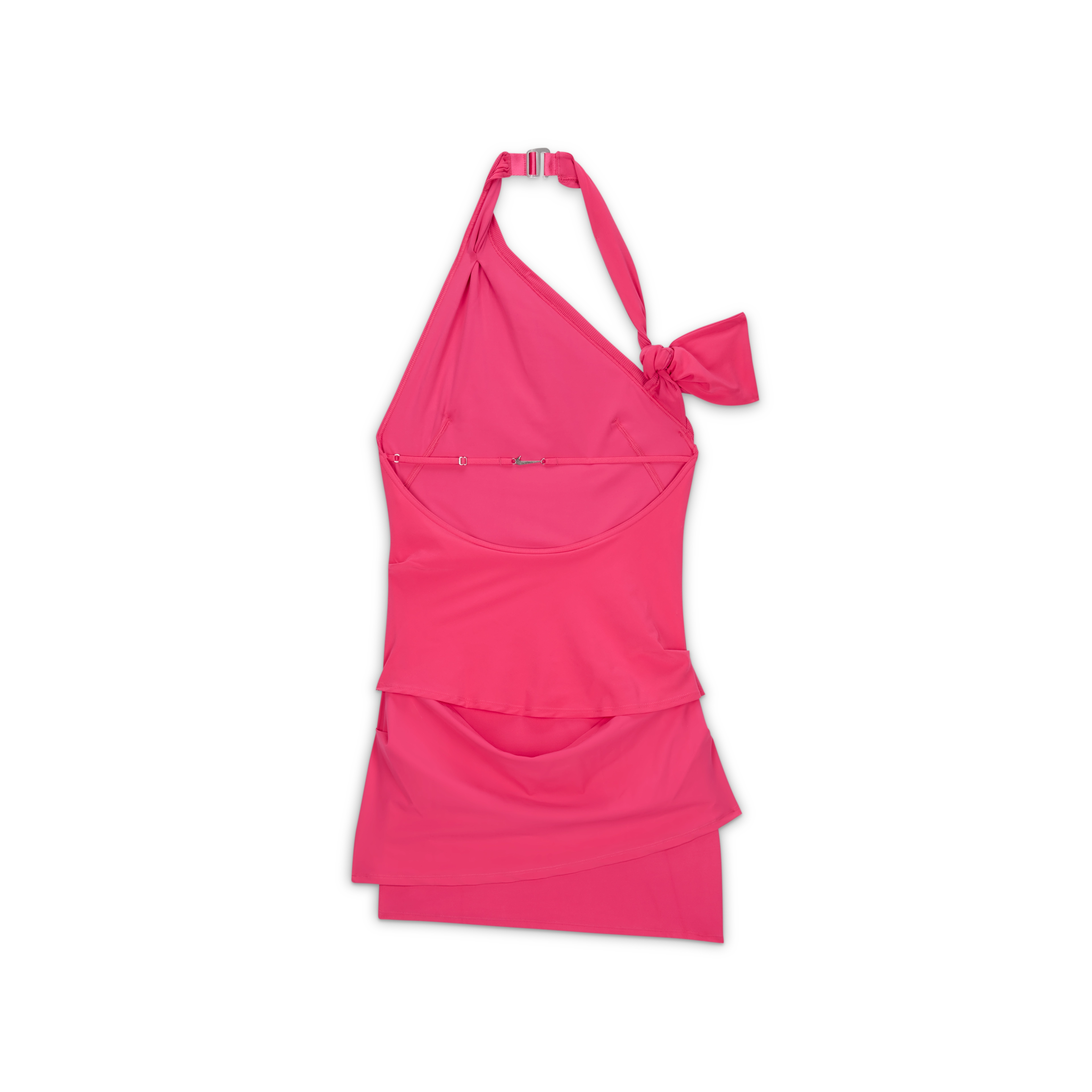 Overhead view of the Nike x Jacquemus Women's Layered Dress in watermelon pink. The form fitting, stretch dress hits at mid to upper thigh, and is sleeveless. There is a strap that attaches at the back of the neck with a silver closure and an arm band that fits over the upper arm. The dress floats on a black background.