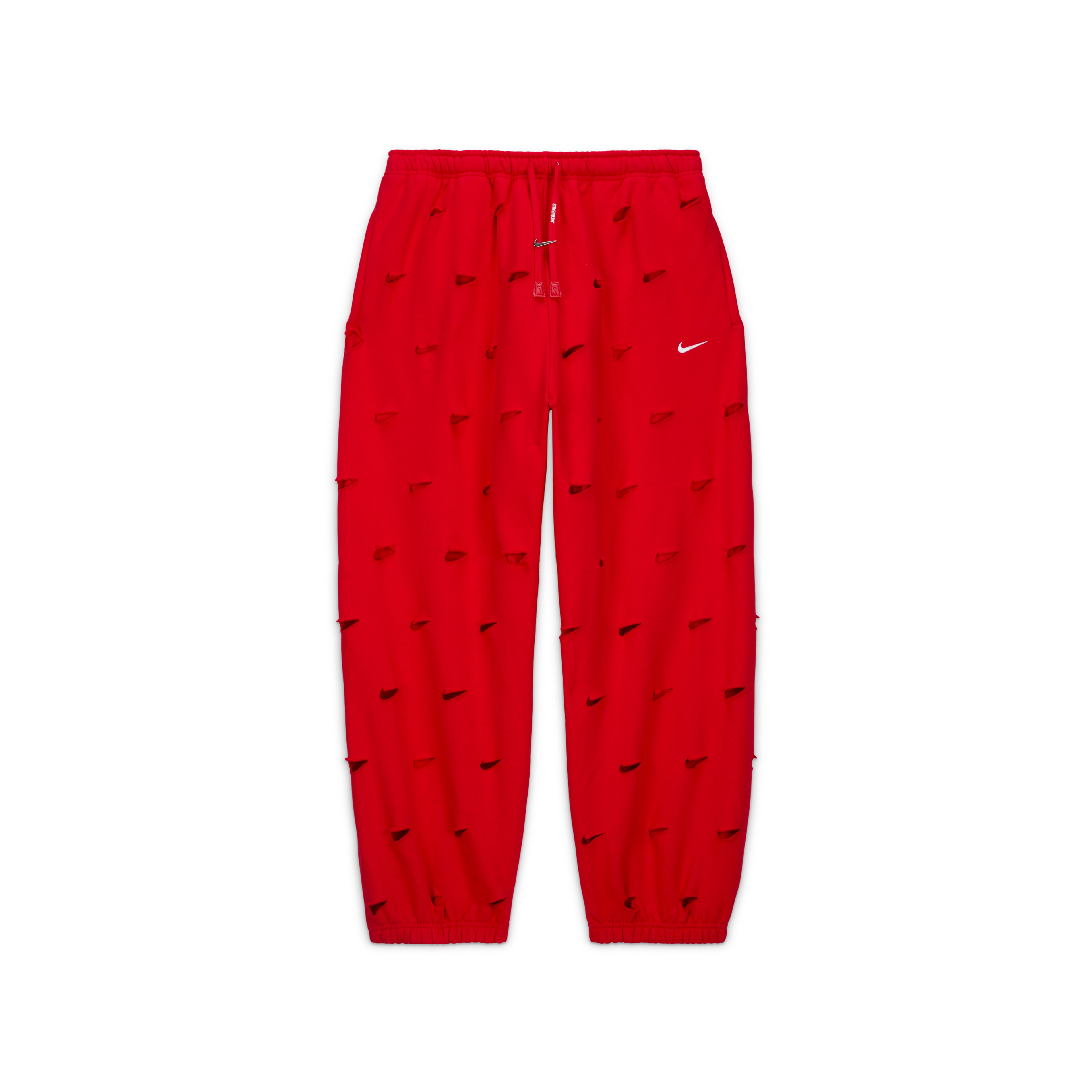 Overhead view of the Nike x Jacquemus Swoosh Pant in University red. Laser cut Swooshes are placed over the entire pant and there is a silver Swoosh logo adorning the drawcord. The pant floats on a black background.