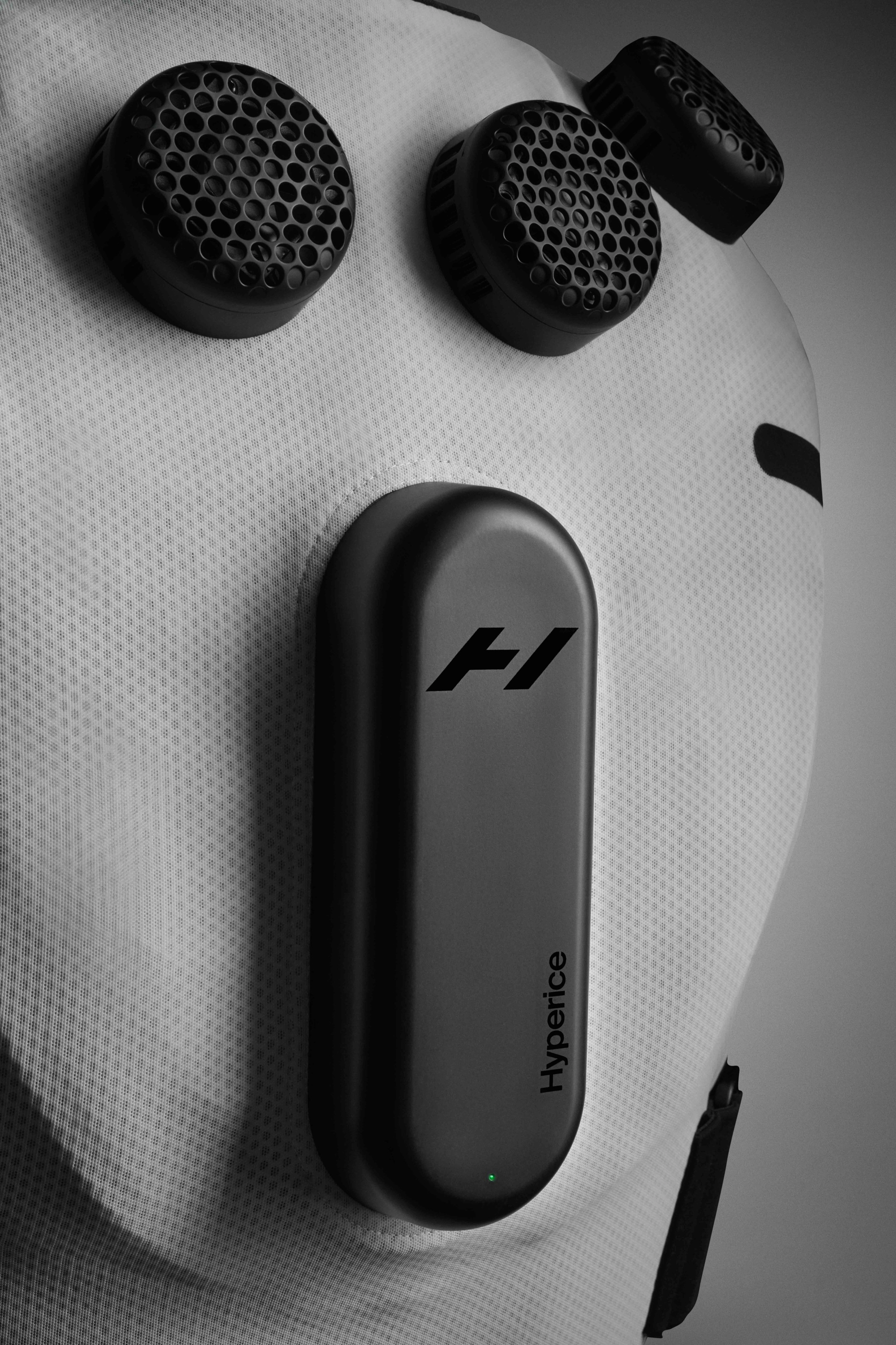 Detail view of Nike x Hyperice Vest thermal modules and compression technology. White vest sits against a grey background.