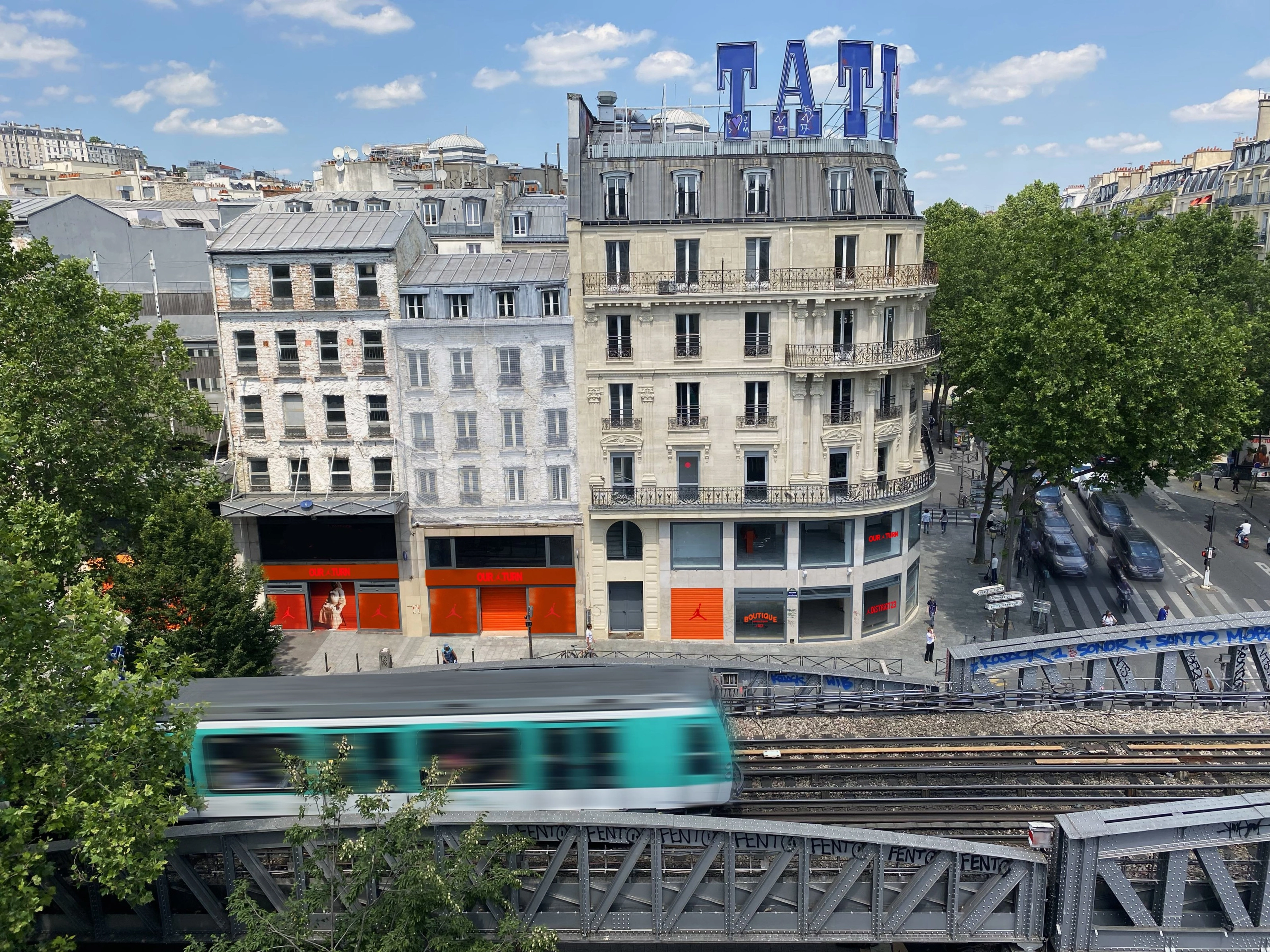 Elevated view of the Nike's District 23 gallery in Paris. The windows feature the Air Jordan logo, as well as "Our turn," "Boutique," and "District 23" in red and orange color schemes.
