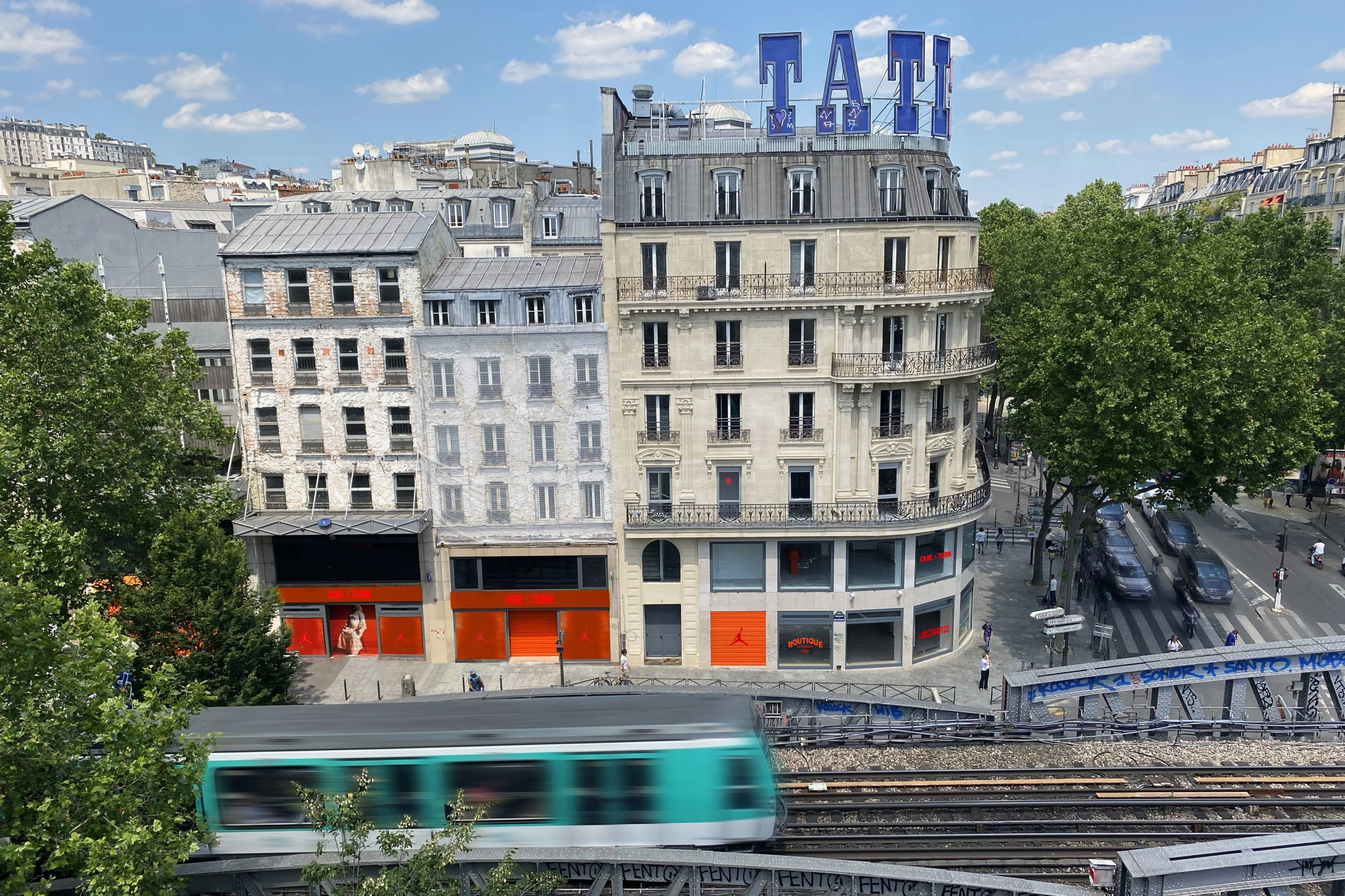 Elevated view of the Nike's District 23 gallery in Paris. The windows feature the Air Jordan logo, as well as "Our turn," "Boutique," and "District 23" in red and orange color schemes.