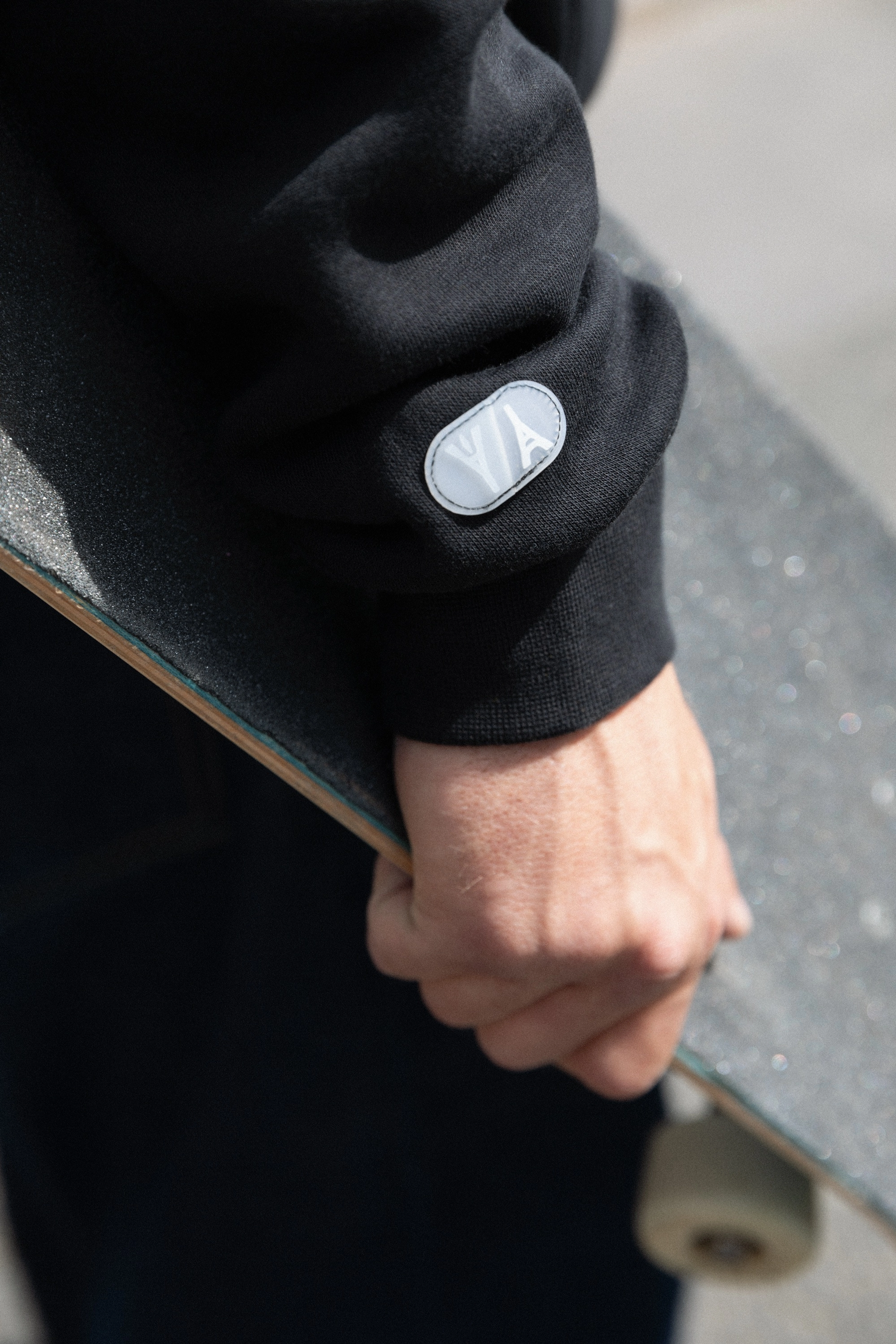 Detail view of the hoodie from the skateboarding federation kits that features a patch of two Eiffel towers flipped in opposite directions at the end of the sleeve.
