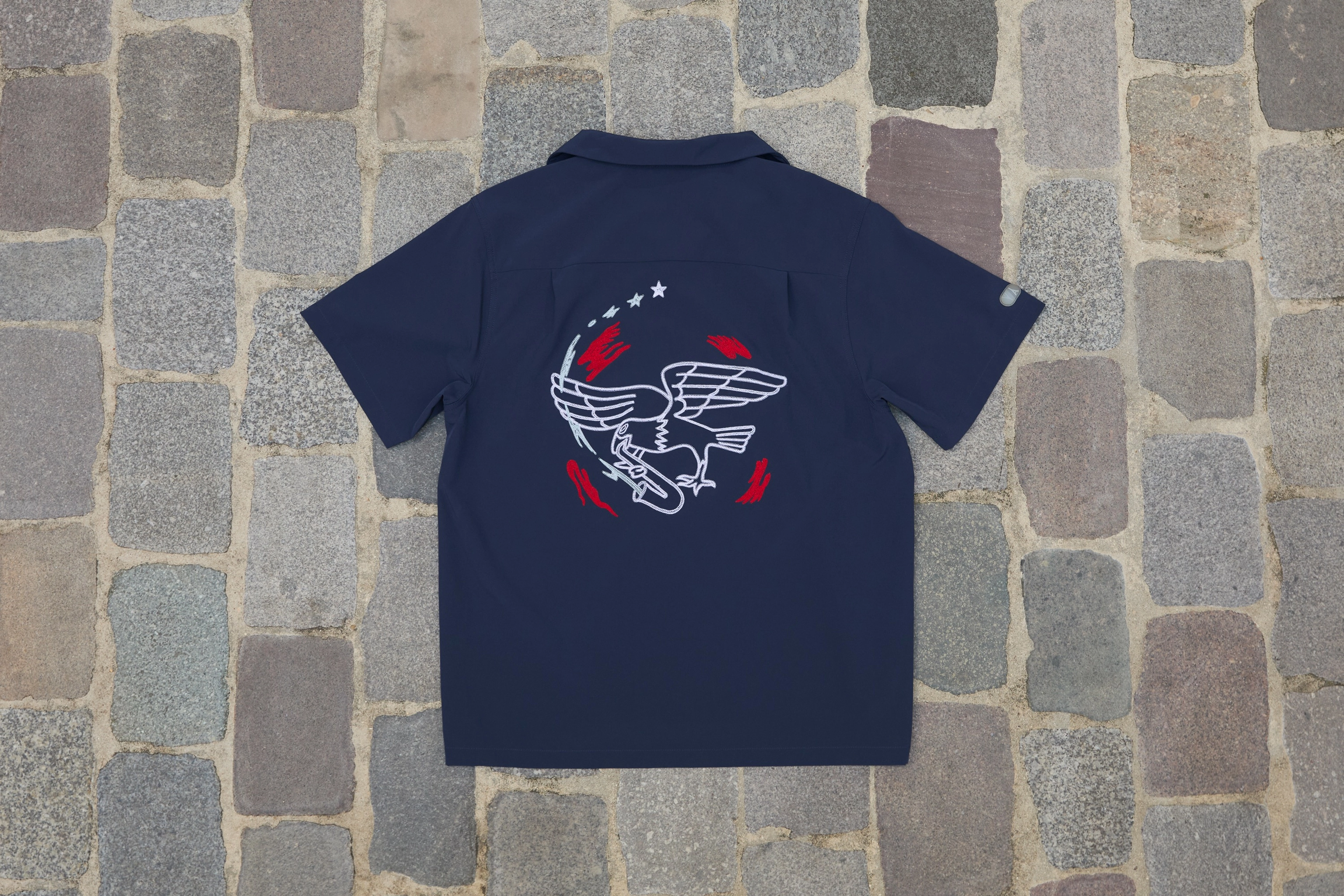 Rear view of the short sleeve button up bowler shirt form the USA skateboarding federation kit