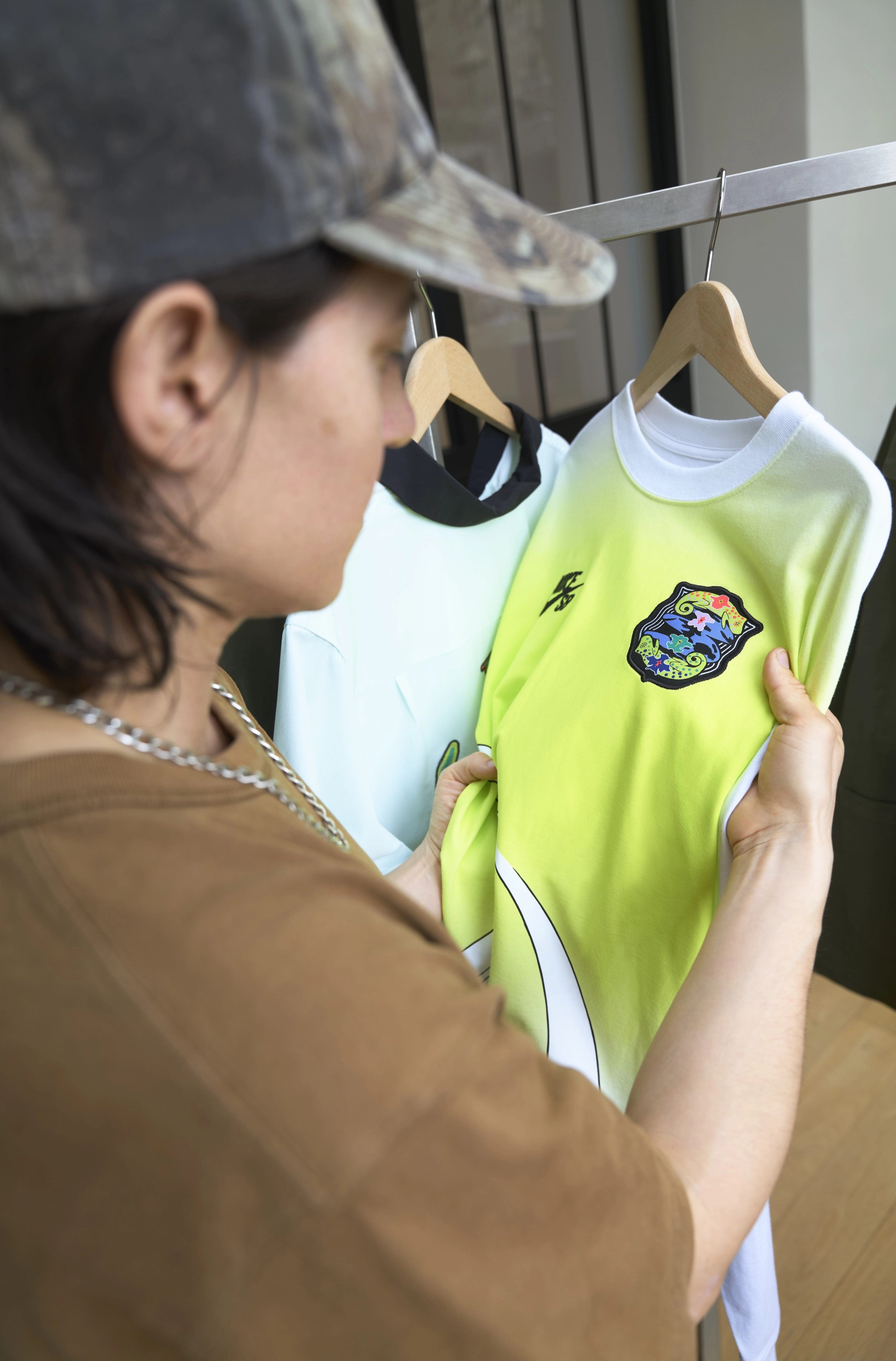 Alexis Sablone holding a Nike SB lime green shirt that's part of the USA skateboarding federation kit.