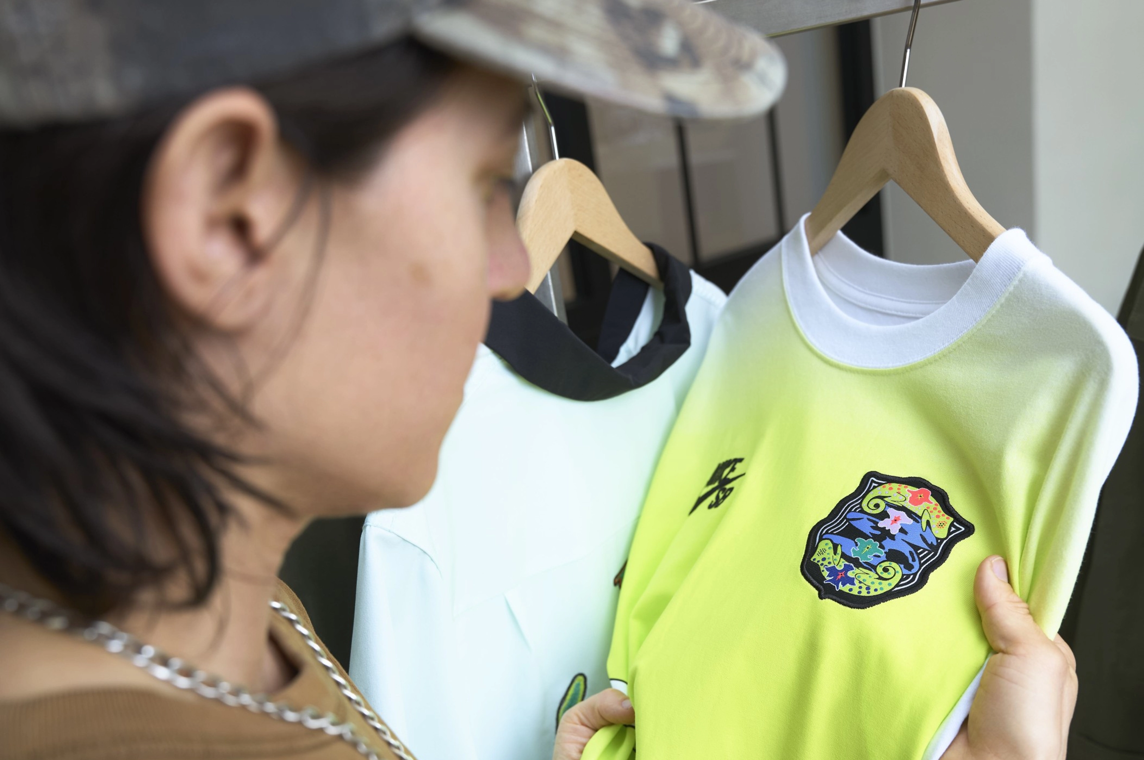 Alexis Sablone holding a Nike SB lime green shirt that's part of the USA skateboarding federation kit.