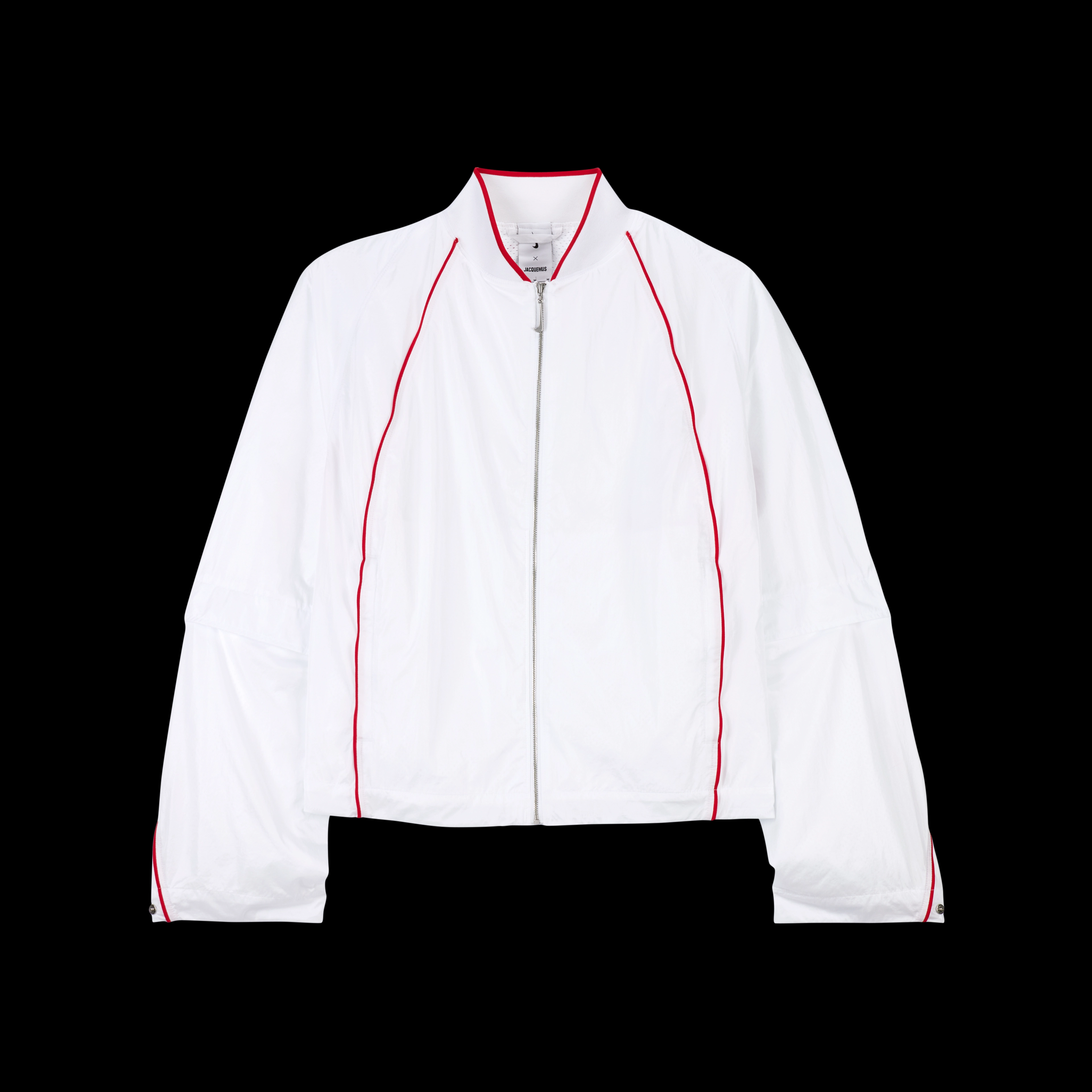 Overhead view of the Nike x Jacquemus Track Jacket in white with university red pinstripes at the neck, across the back and down the sleeve, and on the chest of the jacket. The jacket zipper pull is white in the shape of a Nike Swoosh. The piece floats on a black background.