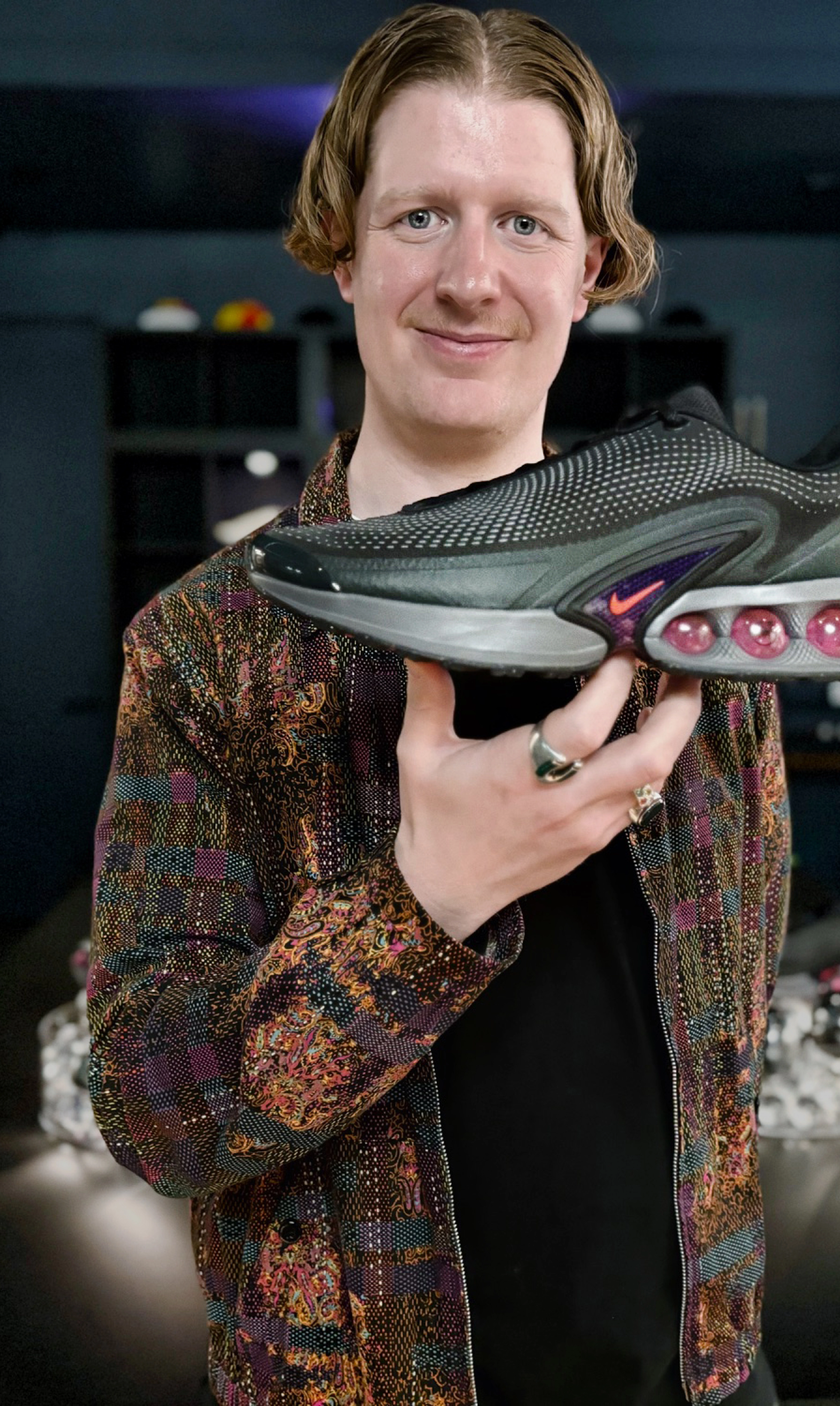 Nike Product Director Reggie Hunter holding up with his right hand the Nike Air Max Dn