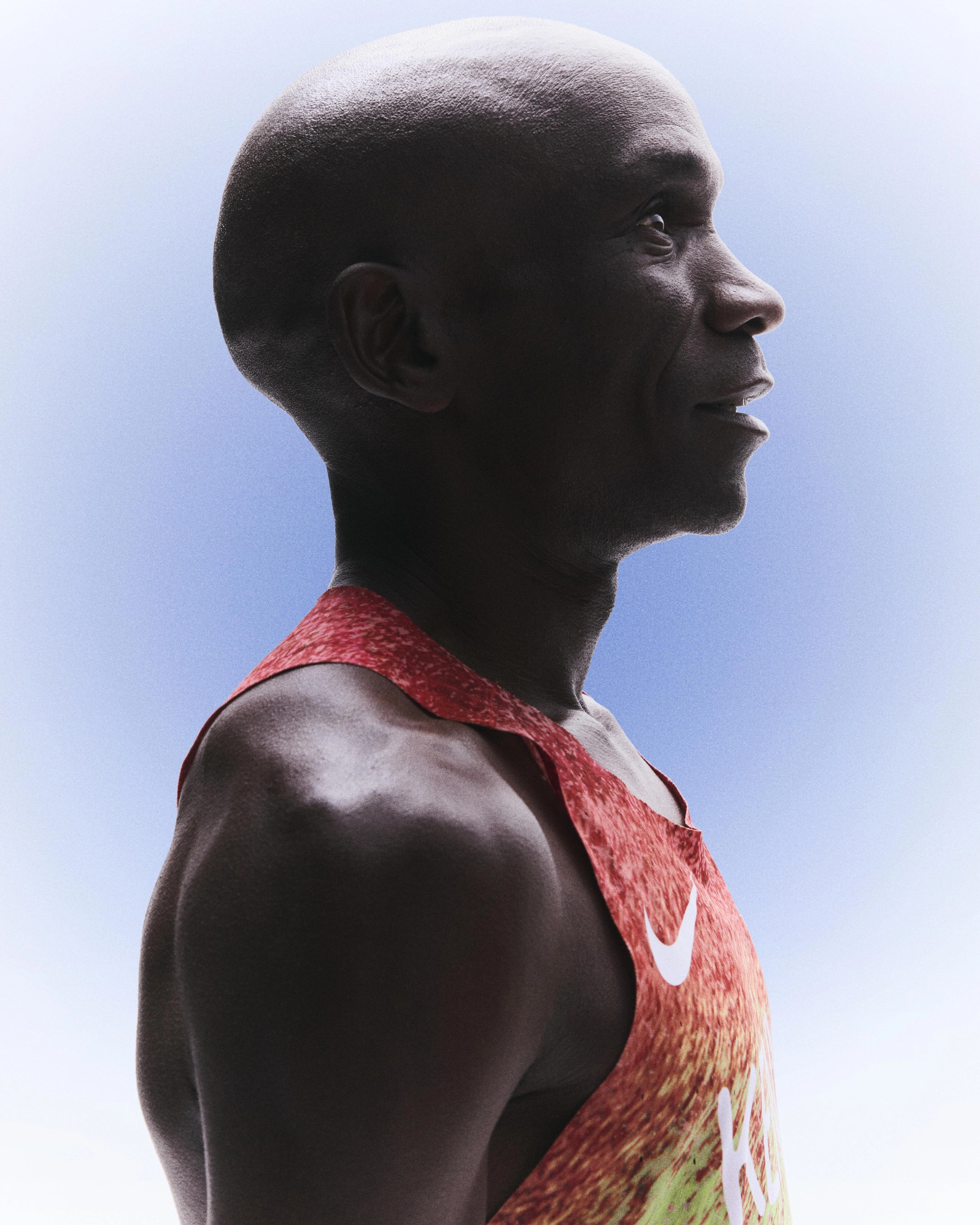 Right side profile view of Eliud Kipchoge wearing Kenya's track and field kit uniform.