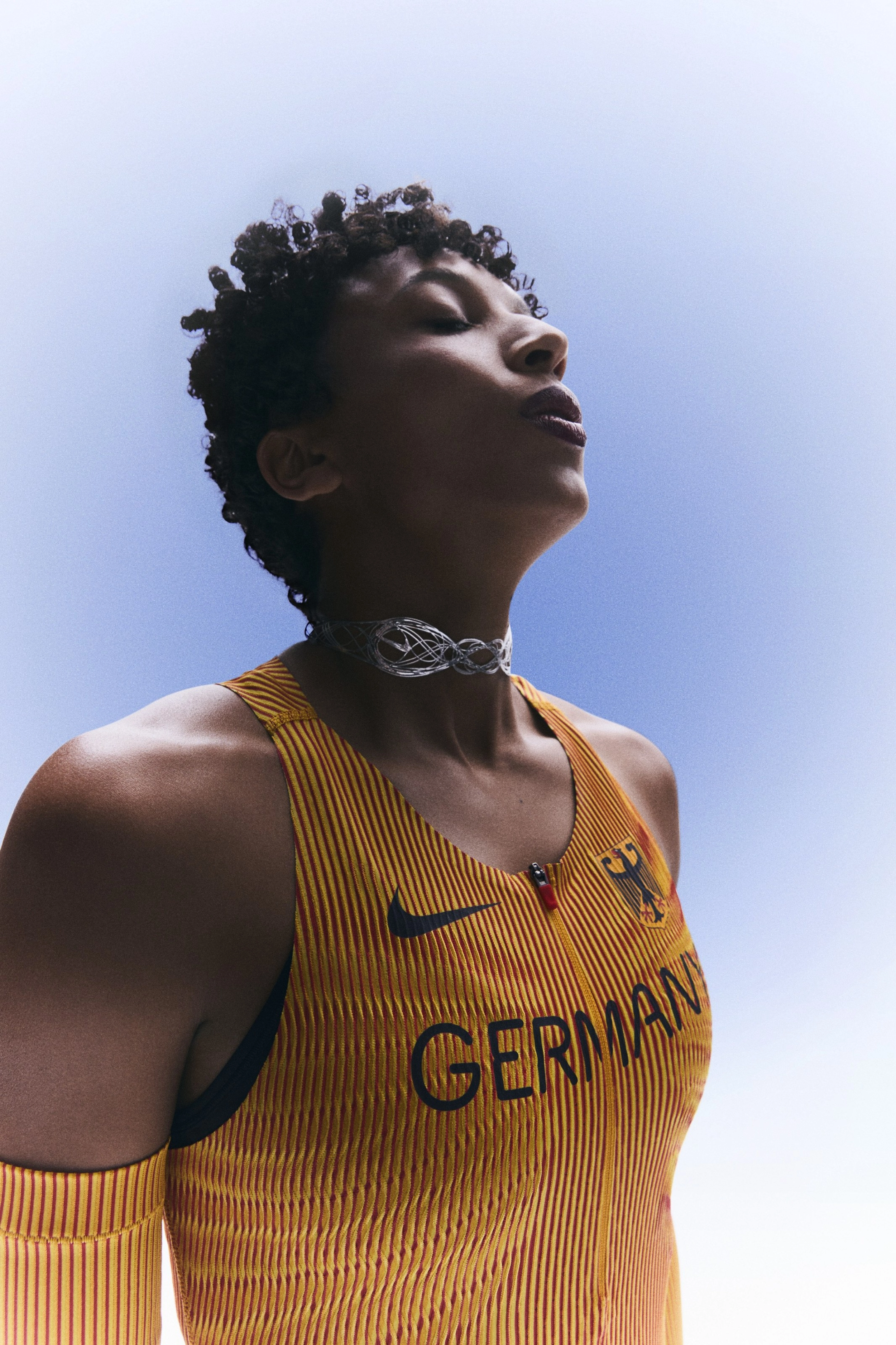 Malaika Mihambo with eyes closed and head tilted up while wearing her Germany track and field kit uniform.
