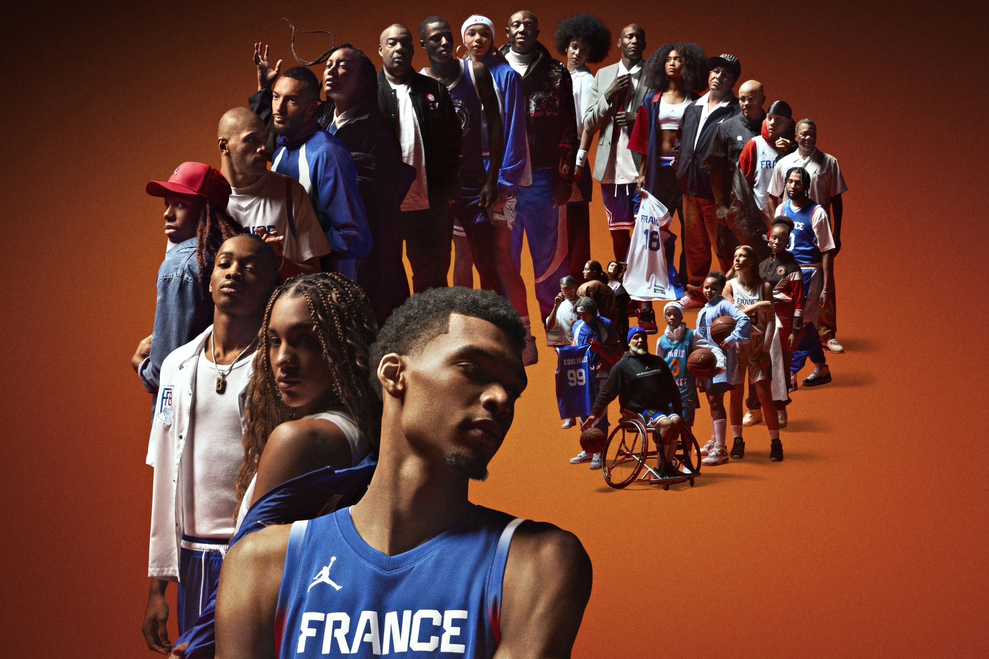 French athletes stand lined up in a spiral formation on an orange background, each sporting articles of clothing from the France Basketball National Team Collection.