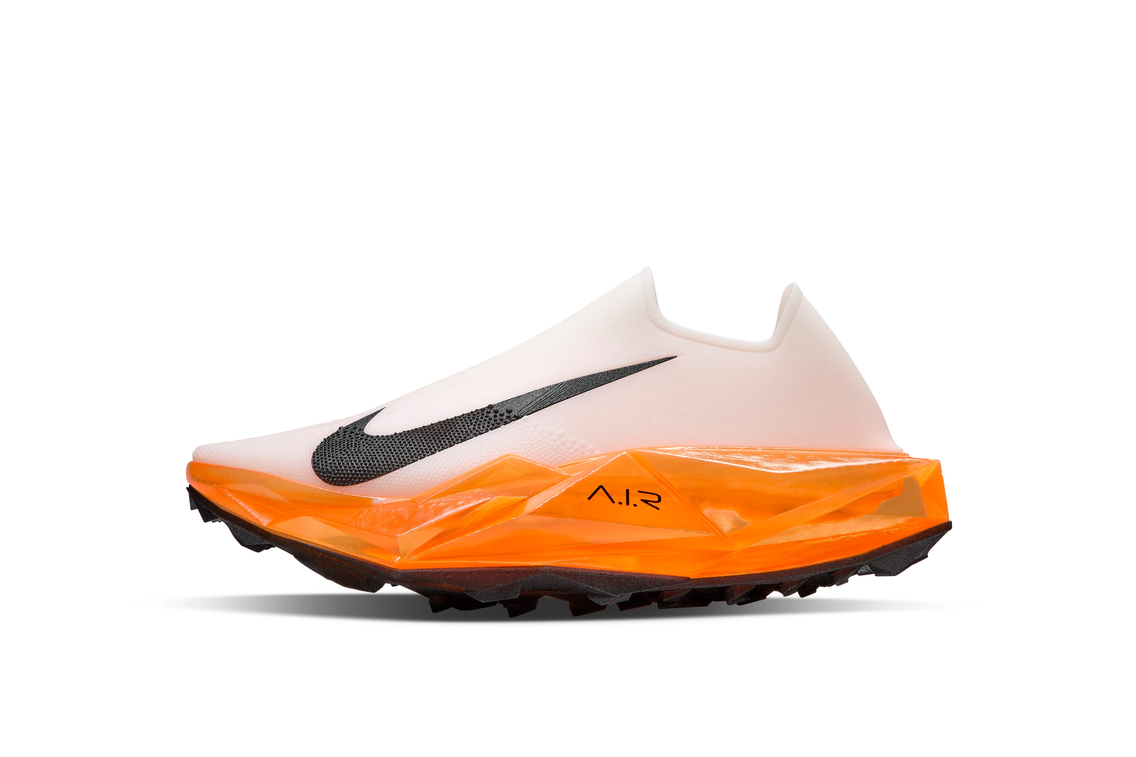 Left view of shoe concept in white for middle distance champion Faith Kipyegon featuring full length air units , a lugged outsole, and a secure bootie like fit for the upper features.