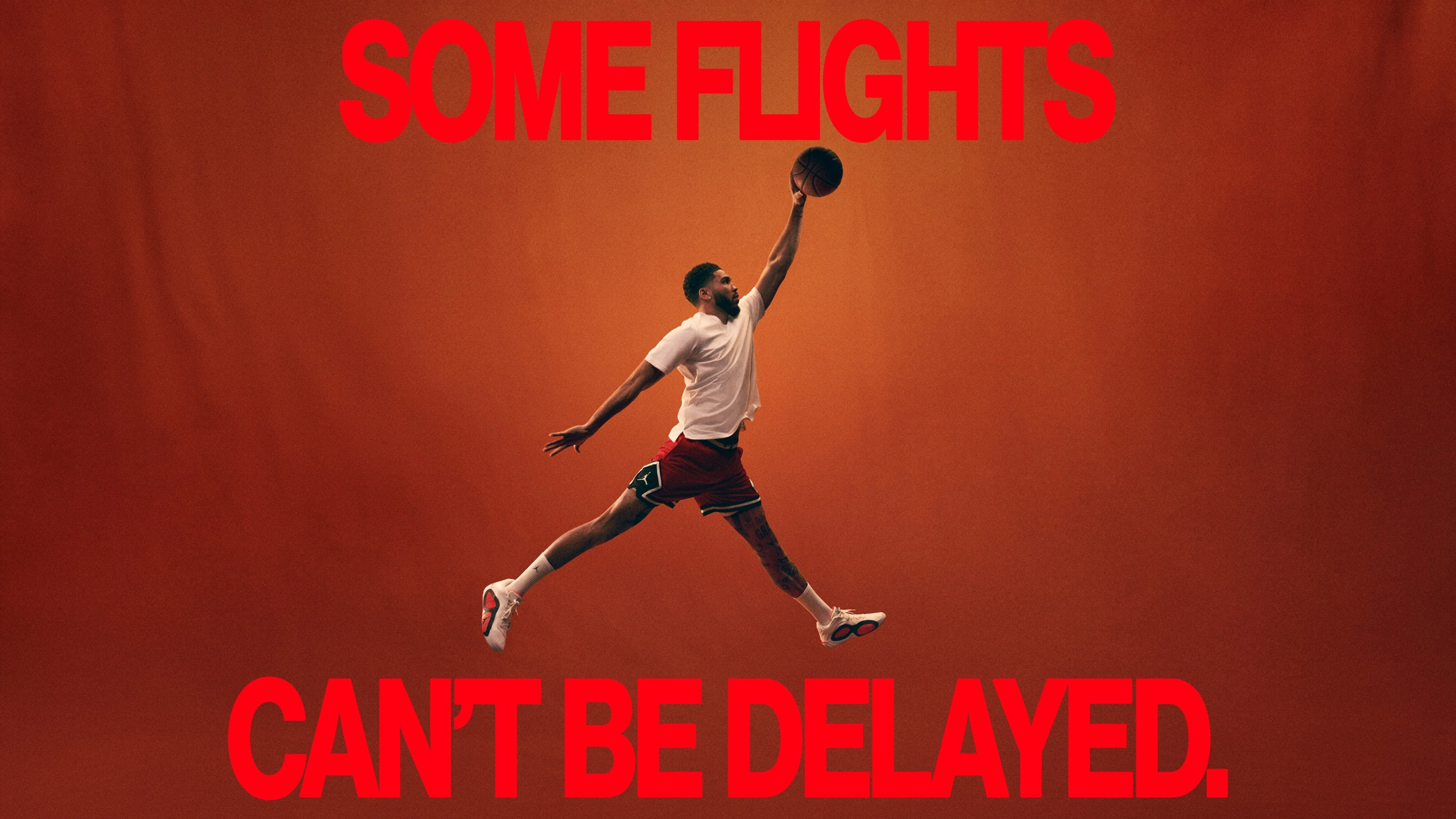 A basketball athlete strikes the Air Jordan dunk pose on an orange background. A caption in red font reads, "Some flights can't be delayed."