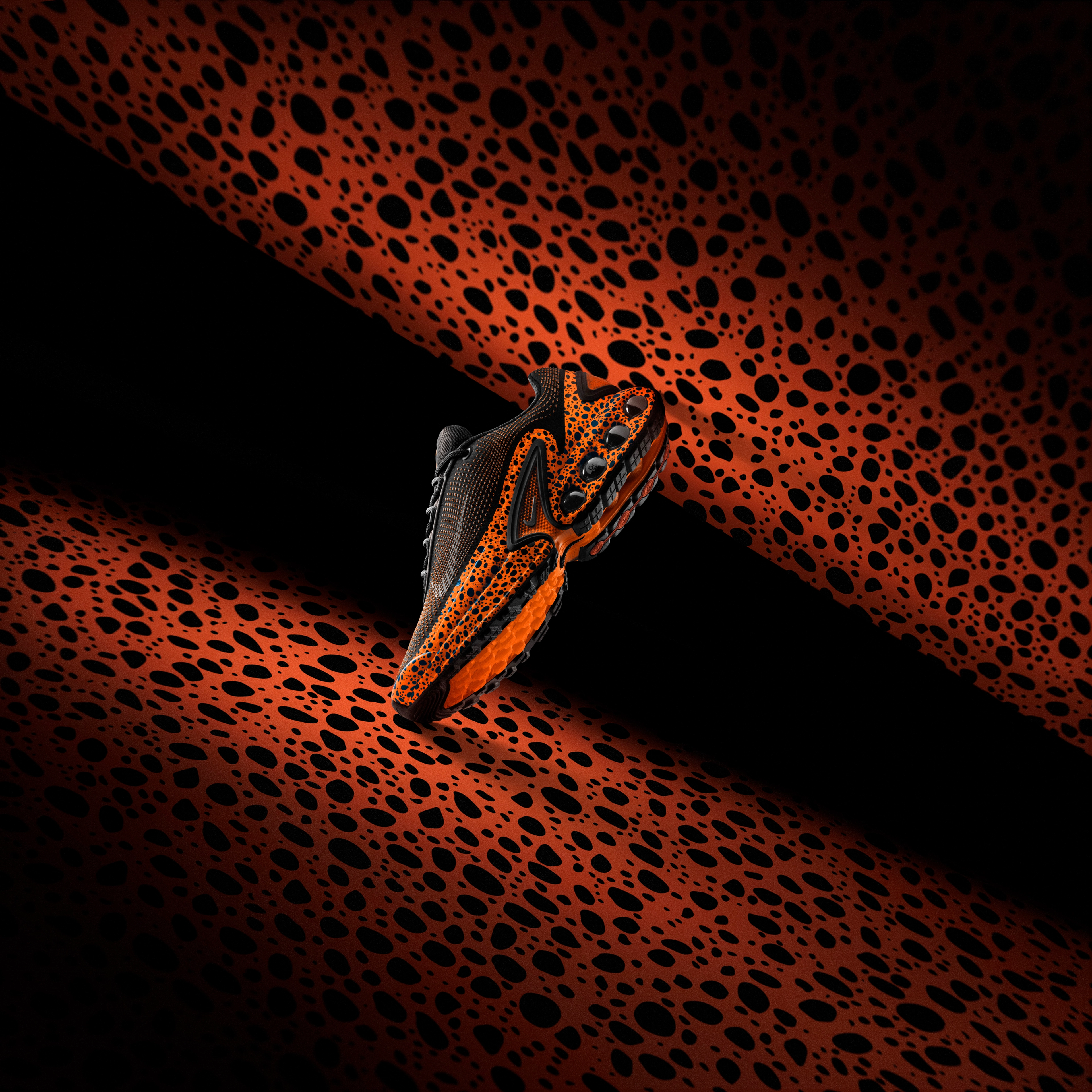 Left view of the Nike Air Max Dn in electric pack color way that combines ostrich print and total orange