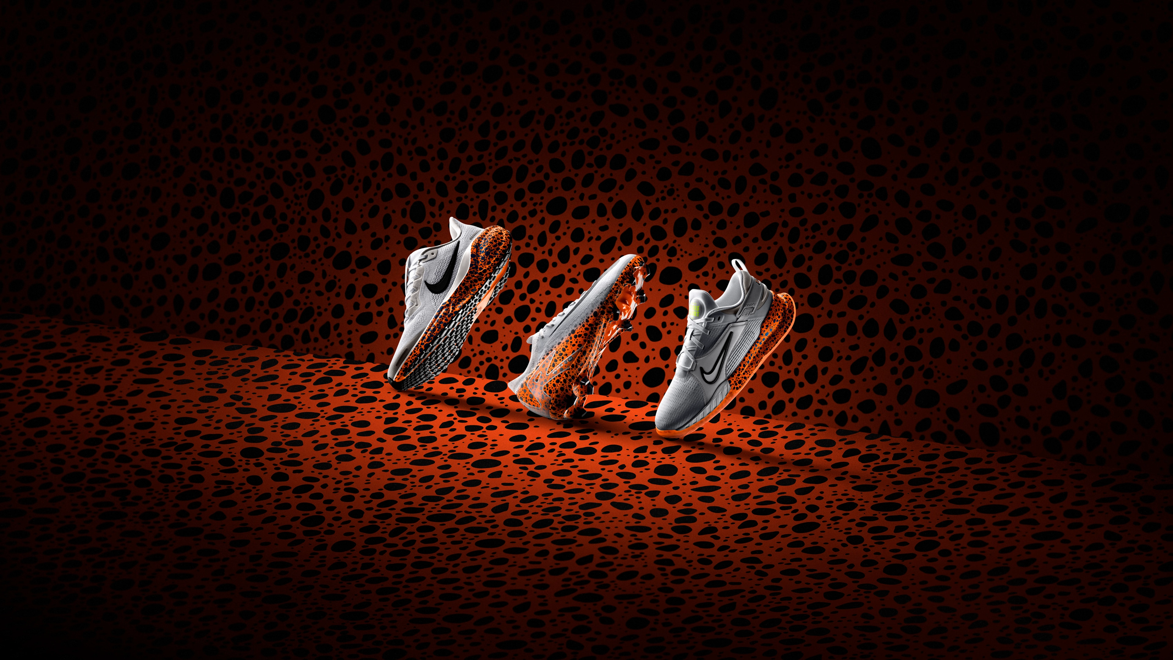 Side view of the Nike Electric Pack for kids, all featuring the Electric pattern, orange with a speckled blue/black spots.