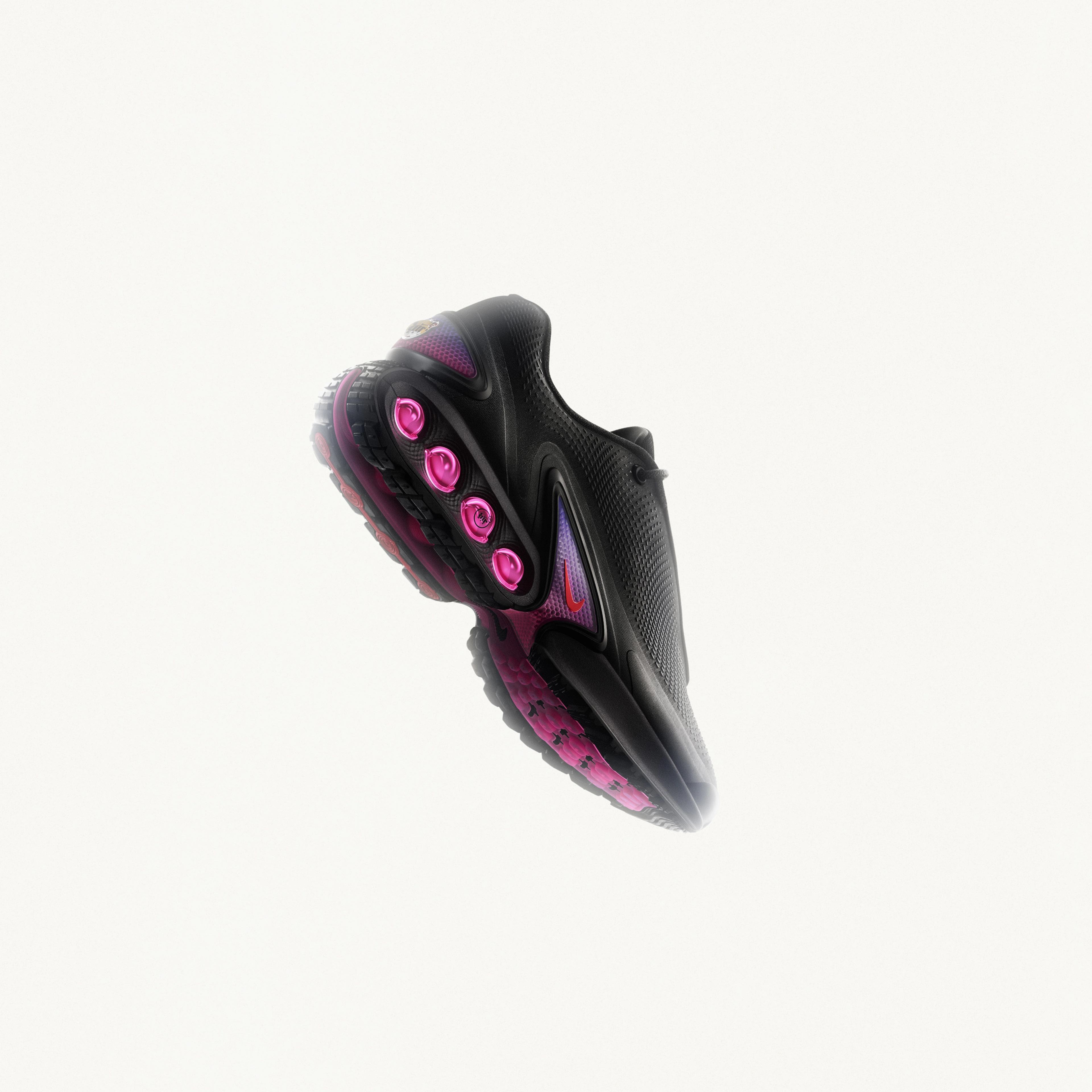 Right angled view of the Nike Air Max Dn in black and dark some grey with light crimson dynamic air unit systems